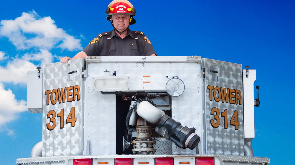 John Tuck in the bucket of a fire truck
