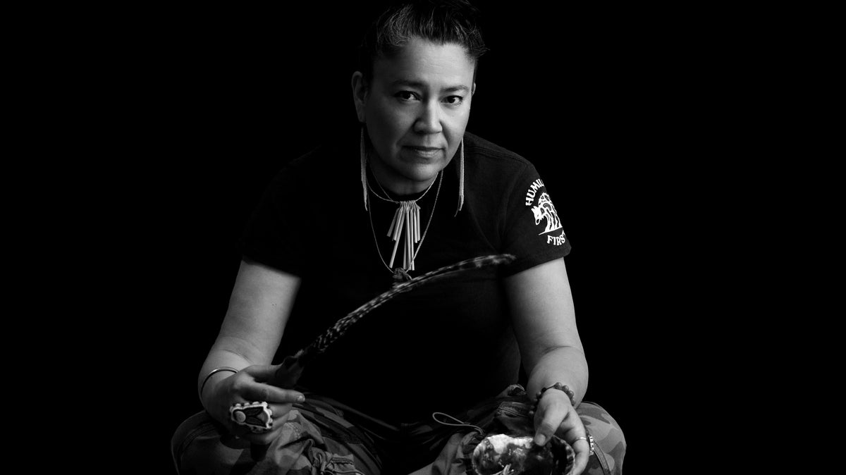 black and white of Johna sitting with a feather