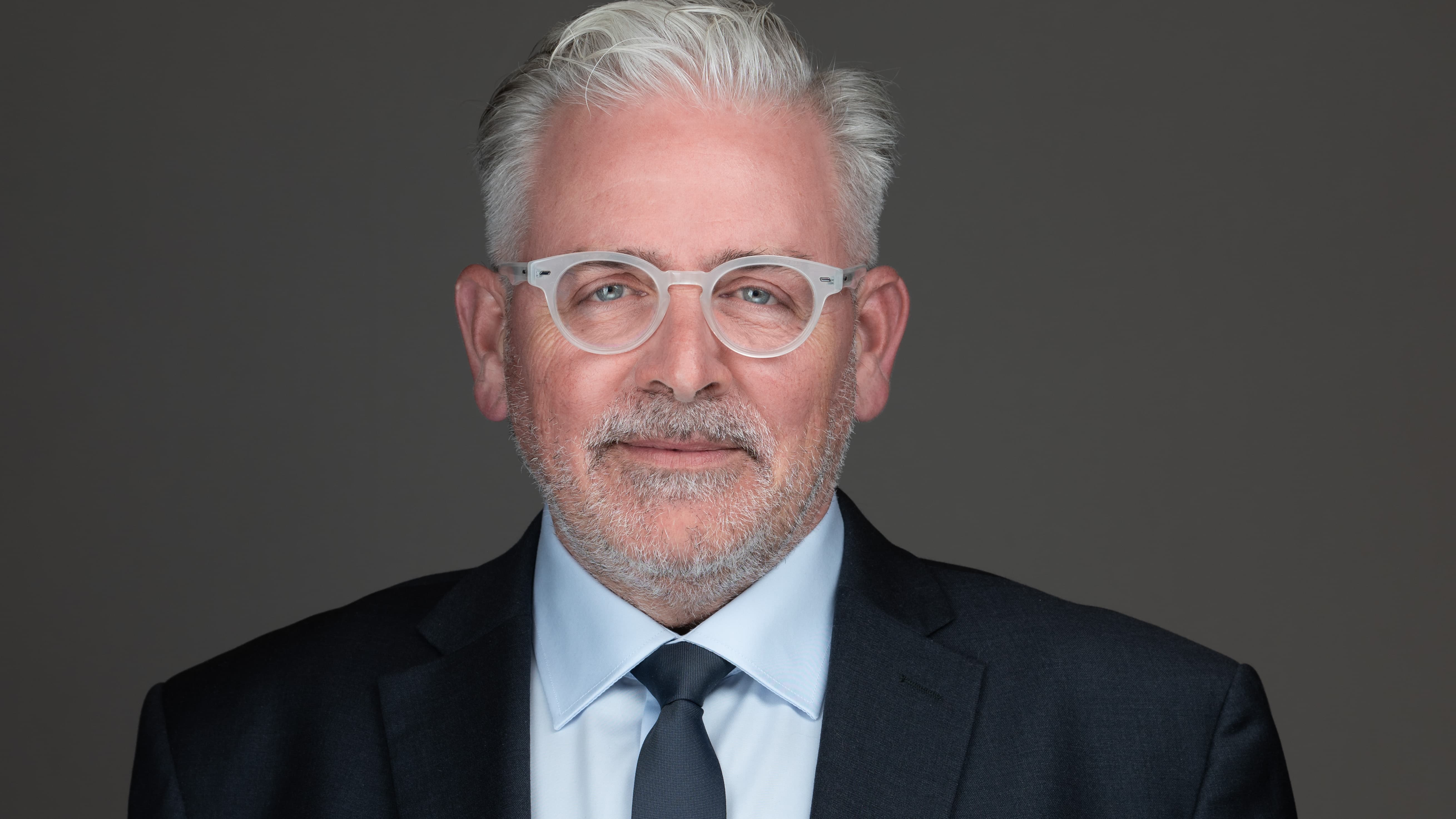 professional headshot of man with glasses
