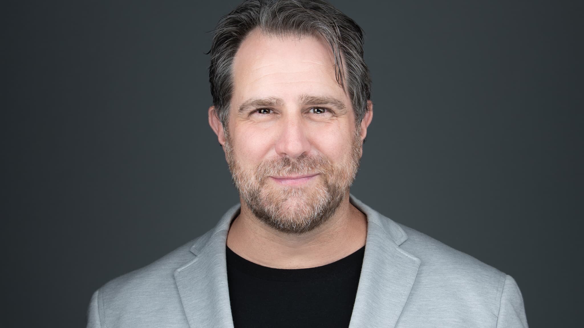 professional headshot of a man with a beard