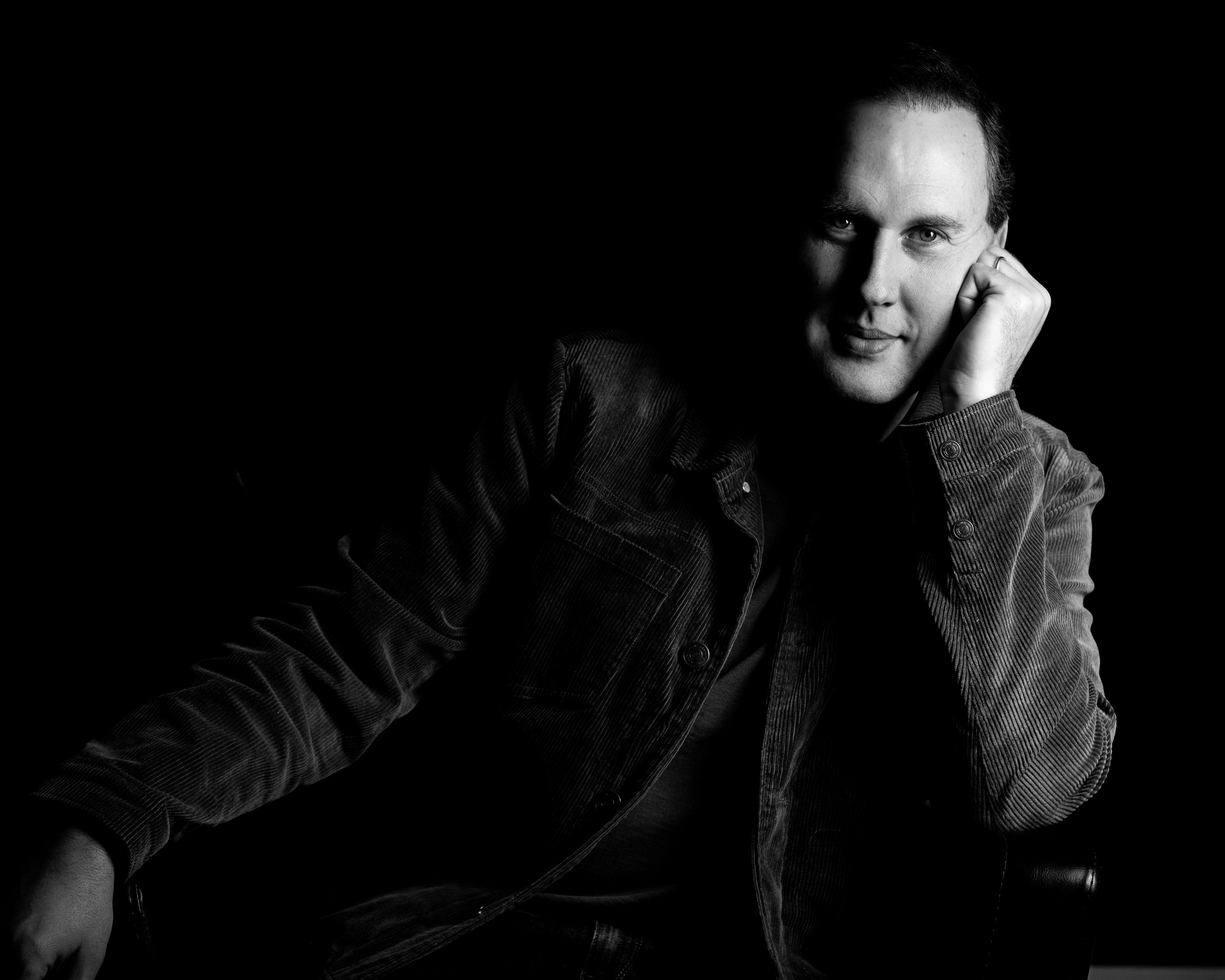 Man sitting in a chair, black and white