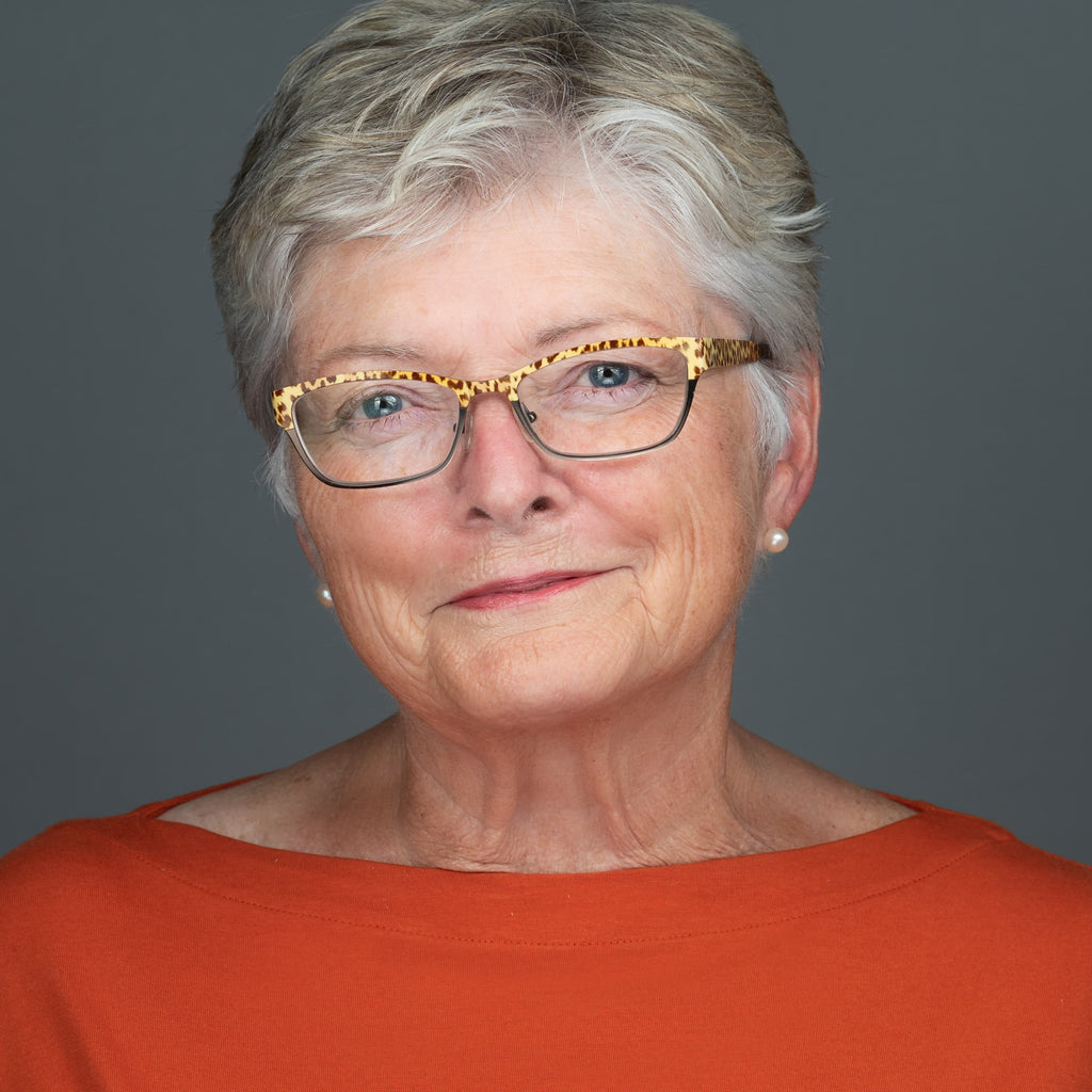 professional headshot of a elderly women wearing glasses