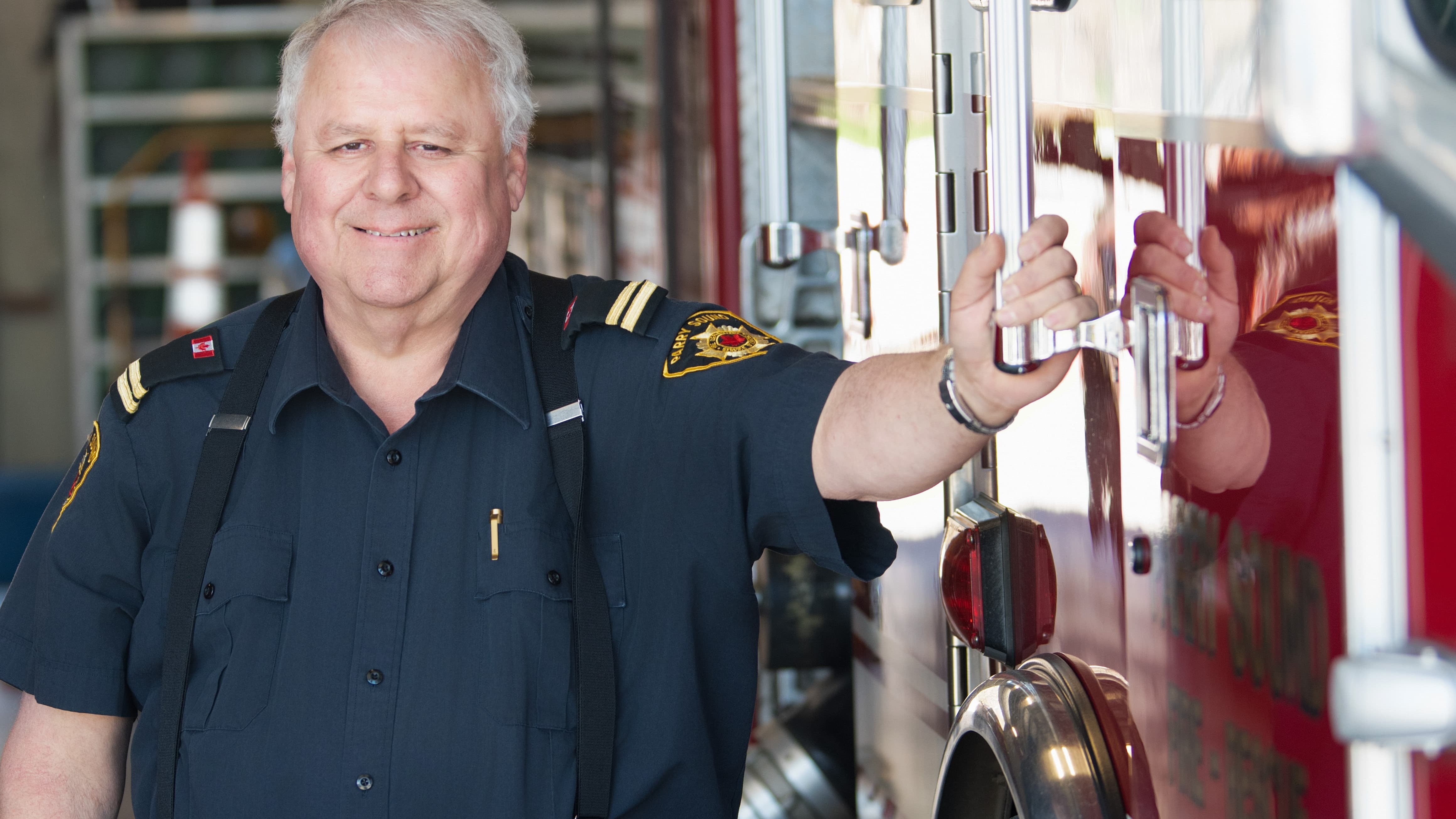 Firefighter standing next to a fire truck