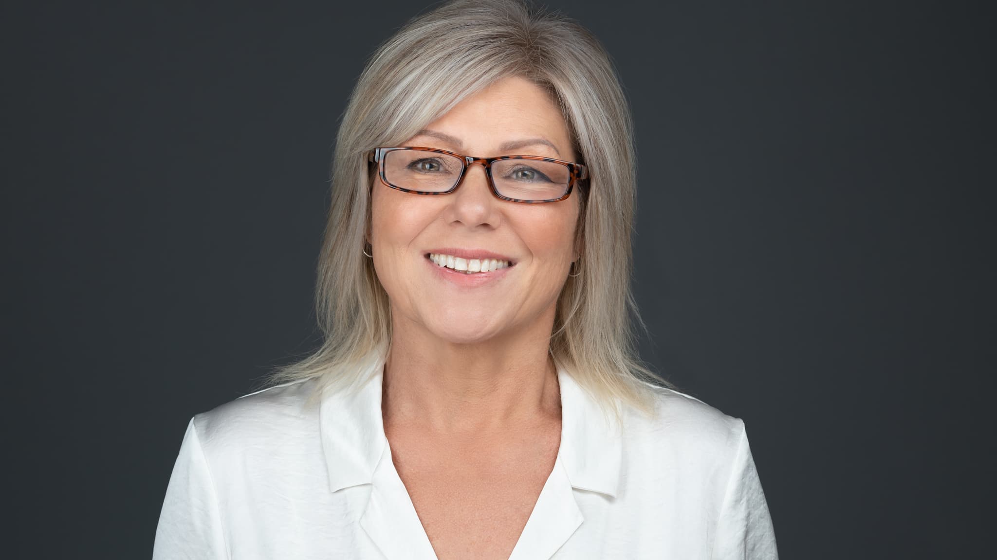 professional headshot of women with glasses