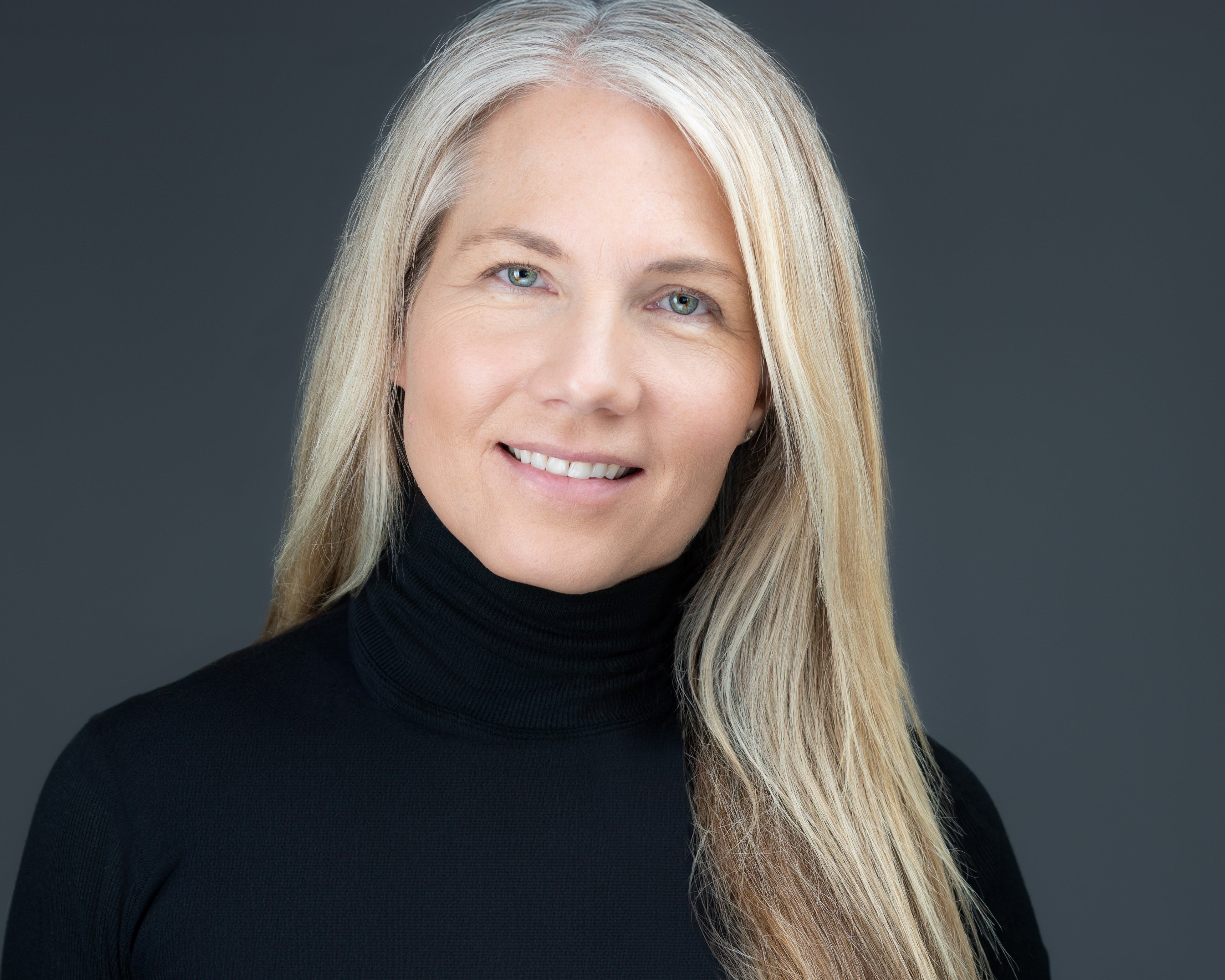 women with blonde hair black turtle neck shirt