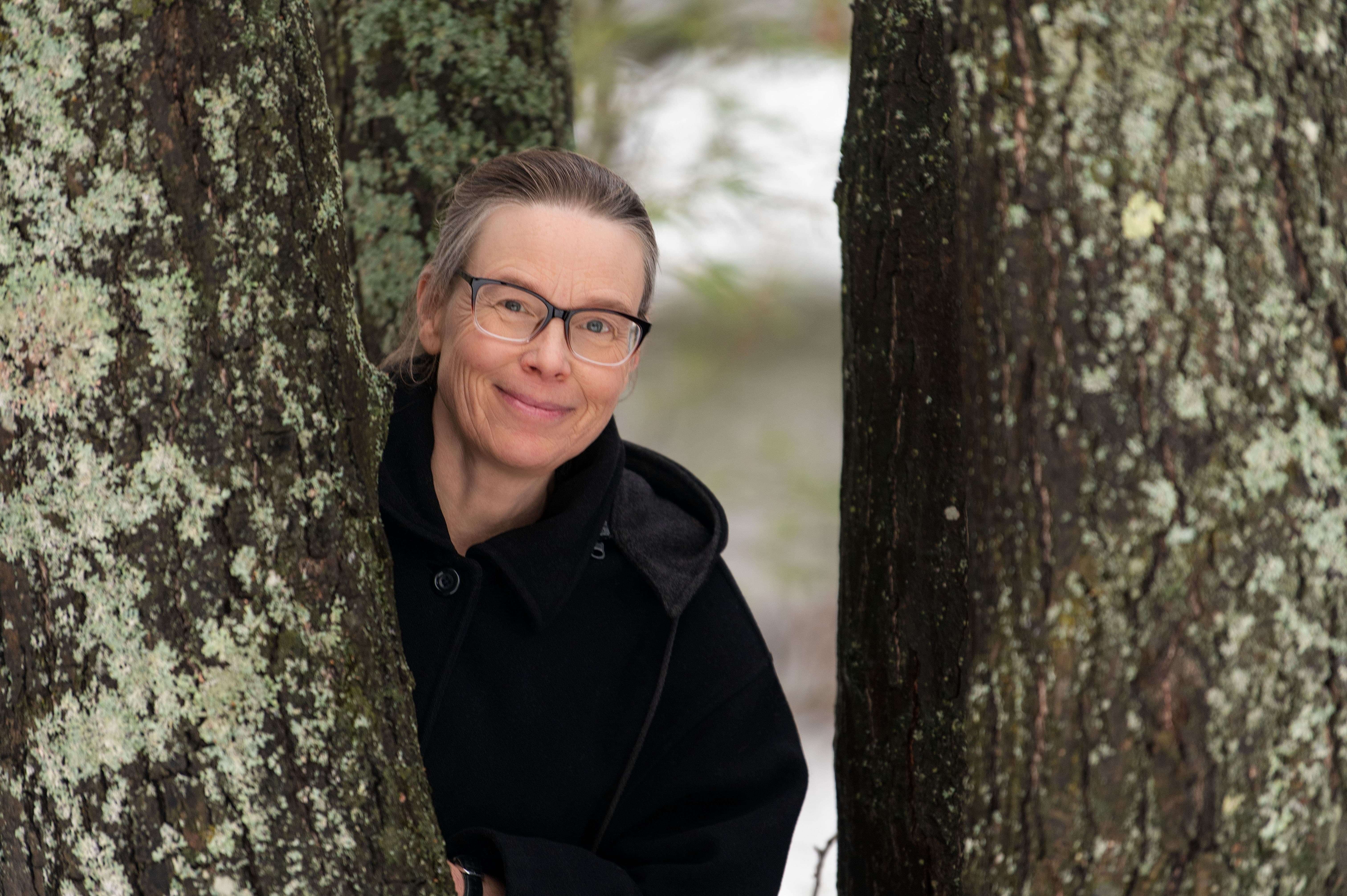 diana clements, parry sound forest school, looking between two trees.