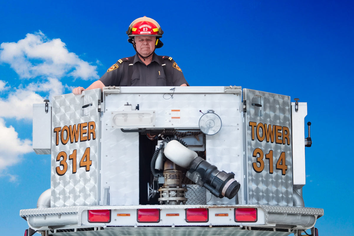 John Tuck in the bucket of a fire truck