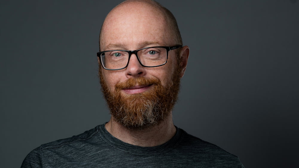 balding man with a red beard and glasses