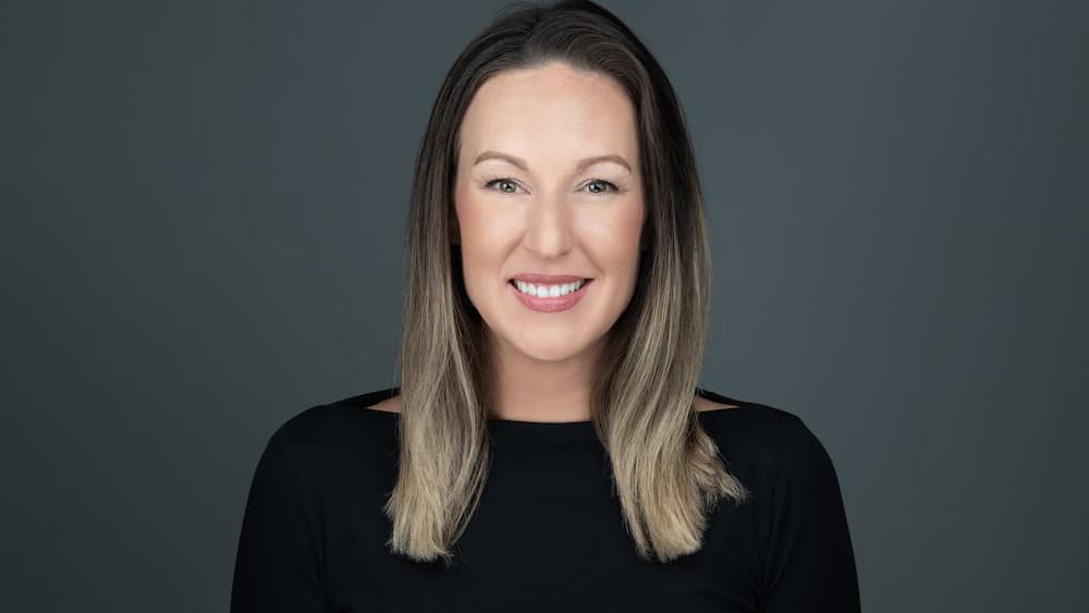 professional headshot of young women wearing a black top
