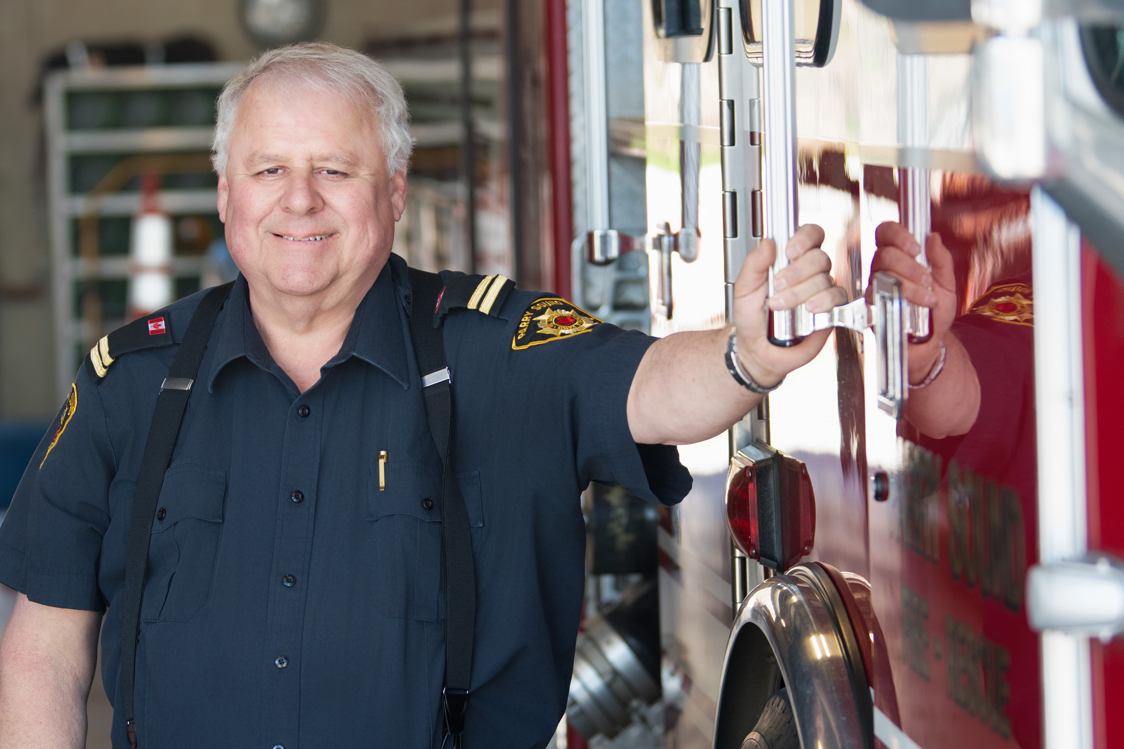 Firefighter standing next to a fire truck