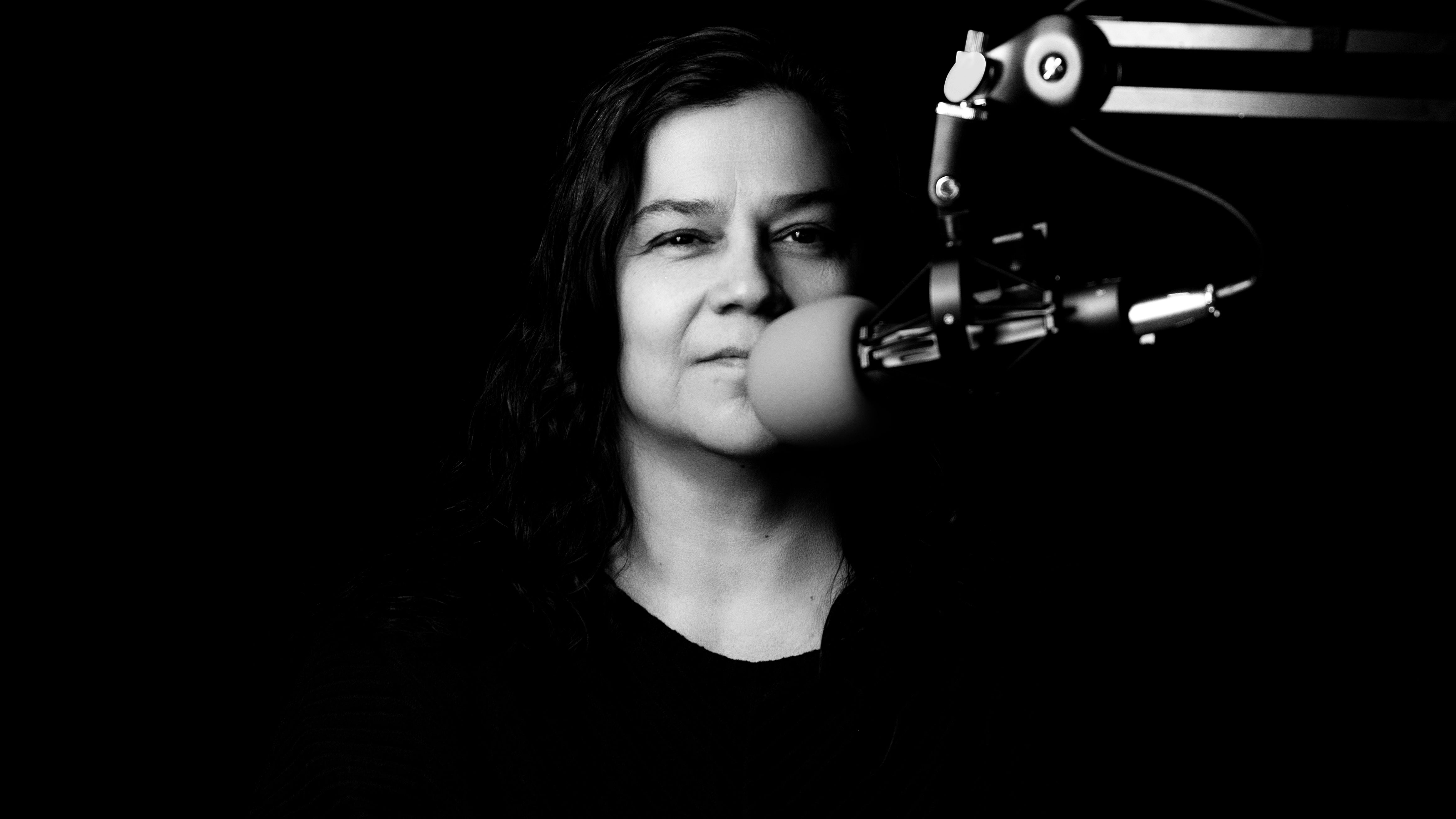 kathy jennings behind  microphone