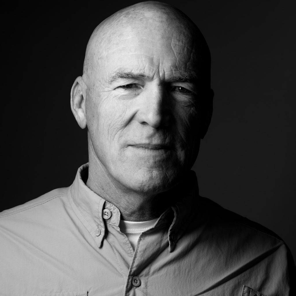black and white professional headshot of man who is bald