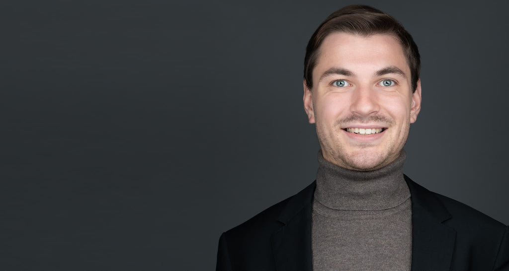professional headshot of young man wearing a turtle neck